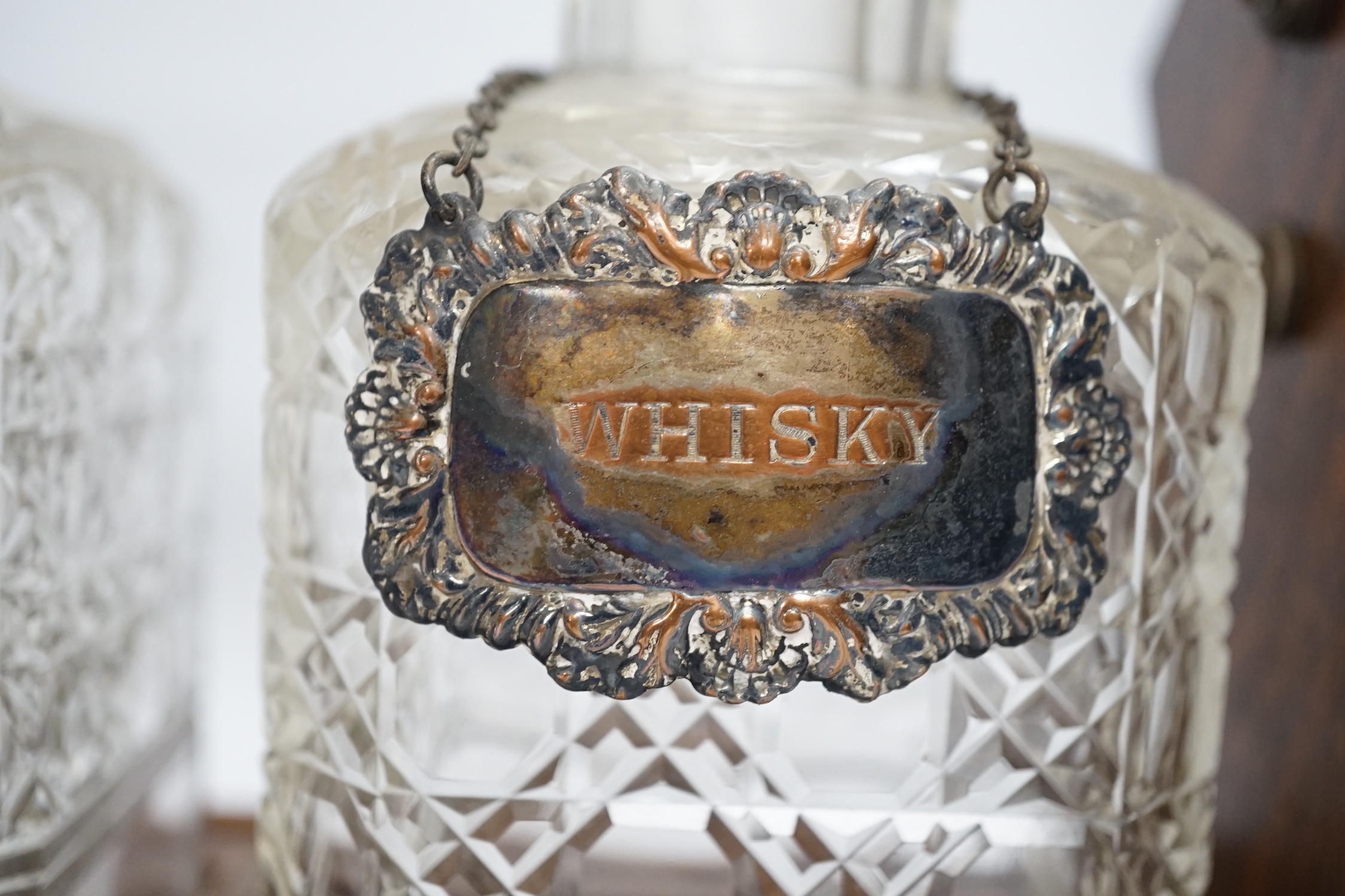 An oak three bottle electroplate tantalus, 29.5cm high